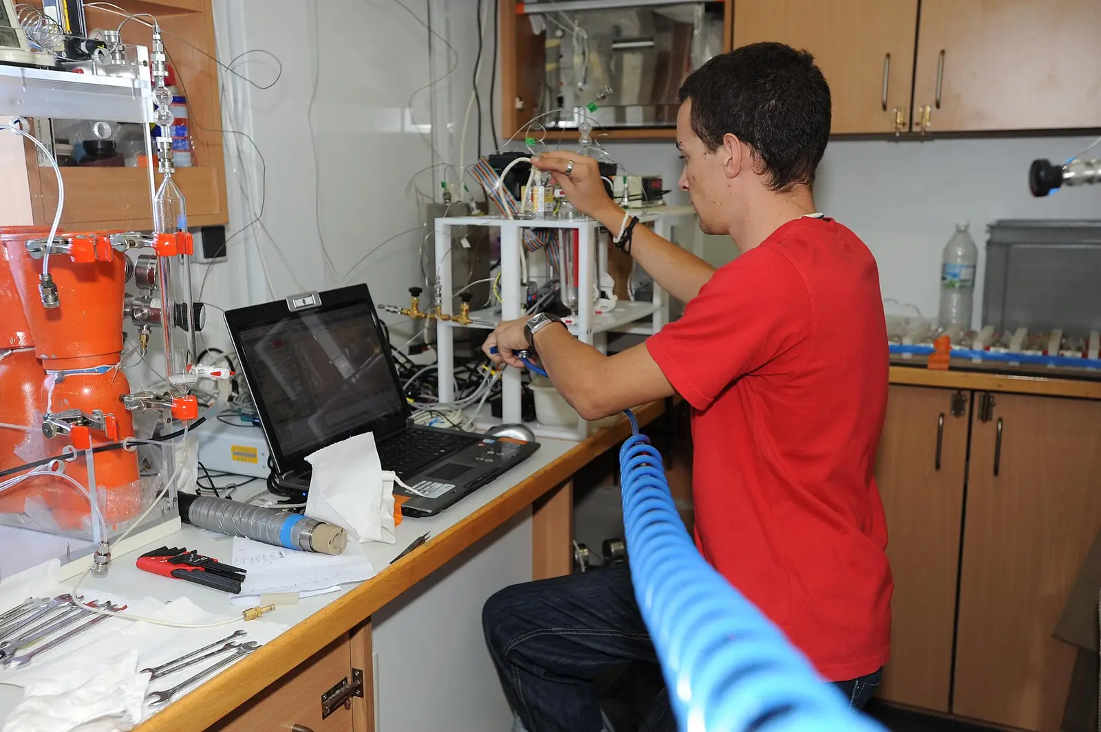 A technician running analyses at a laboratory bench